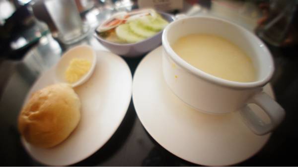 ซุปข้าวโพด ขนมปัง สลัดที่มาเป็นเซตคู่กับสเต็ก ที่ ร้านอาหาร It is A CAKE